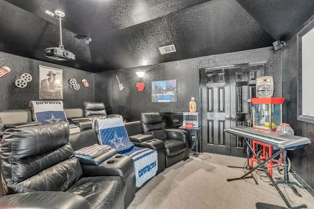 a living room with furniture a chandelier and a flat screen tv