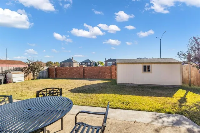 a view of a backyard with a patio