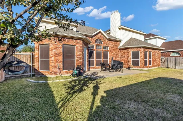 a view of a house with backyard porch and sitting area