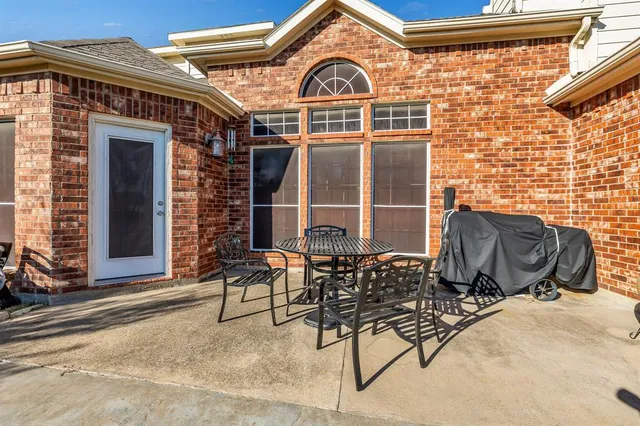 a view of a brick house with large windows