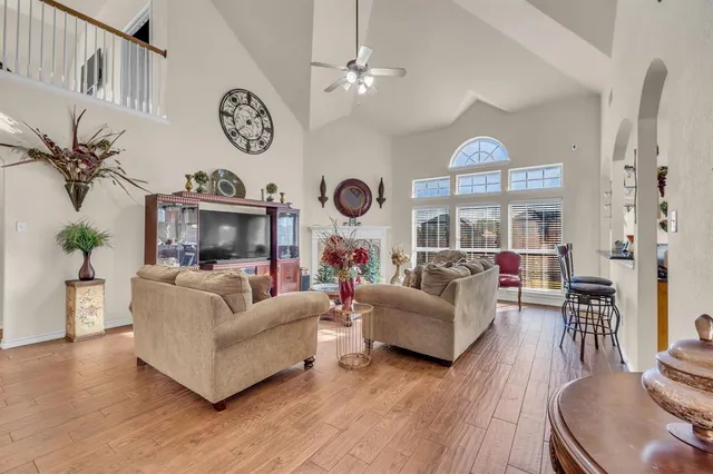 a living room with fireplace furniture and a large window