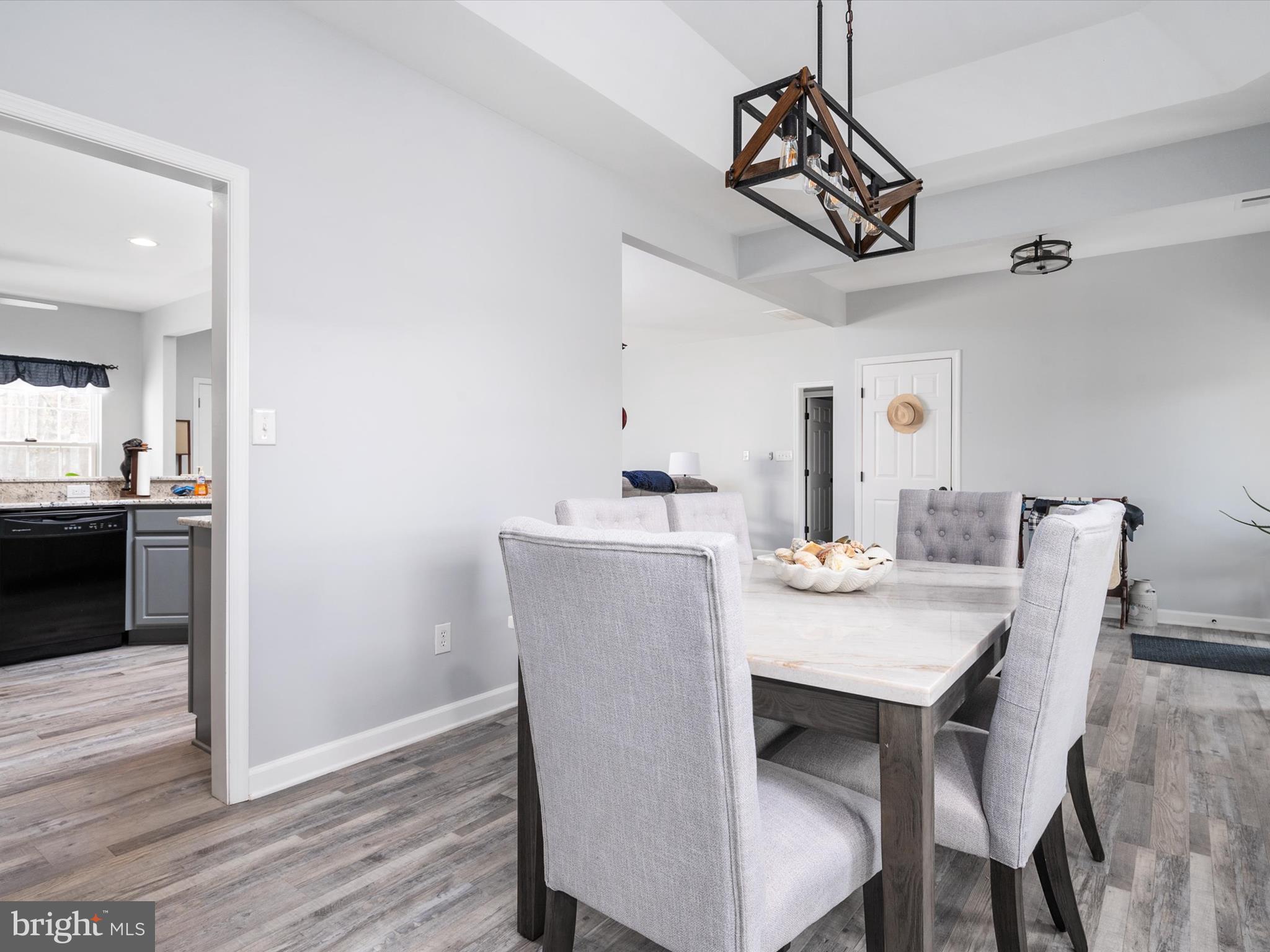 828 Duhamel Corner Road Marydel, MD 21649 - Photo 8 of 52 a dining room with a table chairs and kitchen view