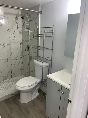 a kitchen with appliances a sink and cabinets