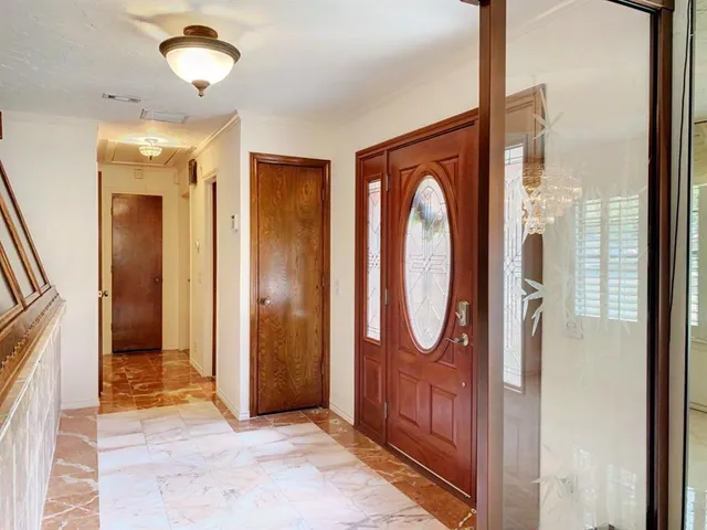 a view of a bathroom with a glass door and mirror