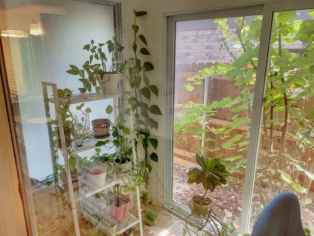 a dining room filled with furniture and a floor to ceiling window