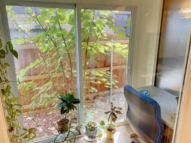 a living room with furniture and a floor to ceiling window