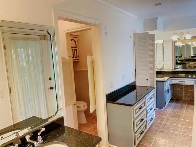 a kitchen with granite countertop a refrigerator and a stove