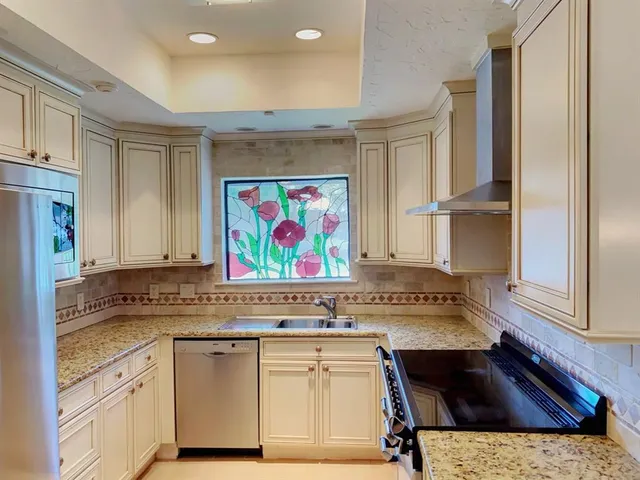 a view of cabinets window and stainless steel appliances