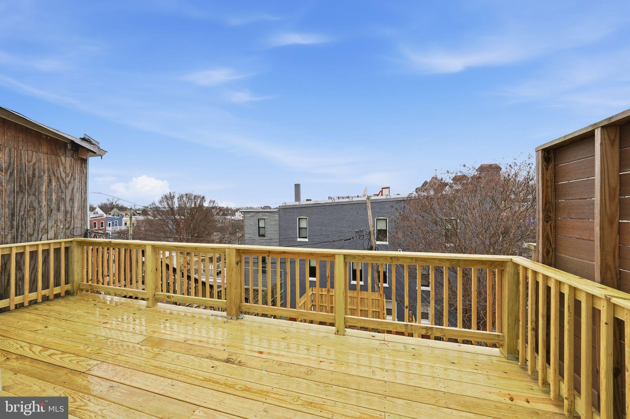 2032 North Capitol Street Northwest, Unit 1 Washington, DC 20002 - Photo 13 of 14 a view of a balcony with wooden floor and city view