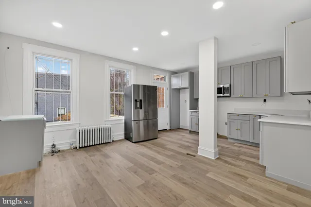 a kitchen with stainless steel appliances a refrigerator and a stove top oven