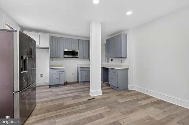 a kitchen with stainless steel appliances a refrigerator and a stove top oven