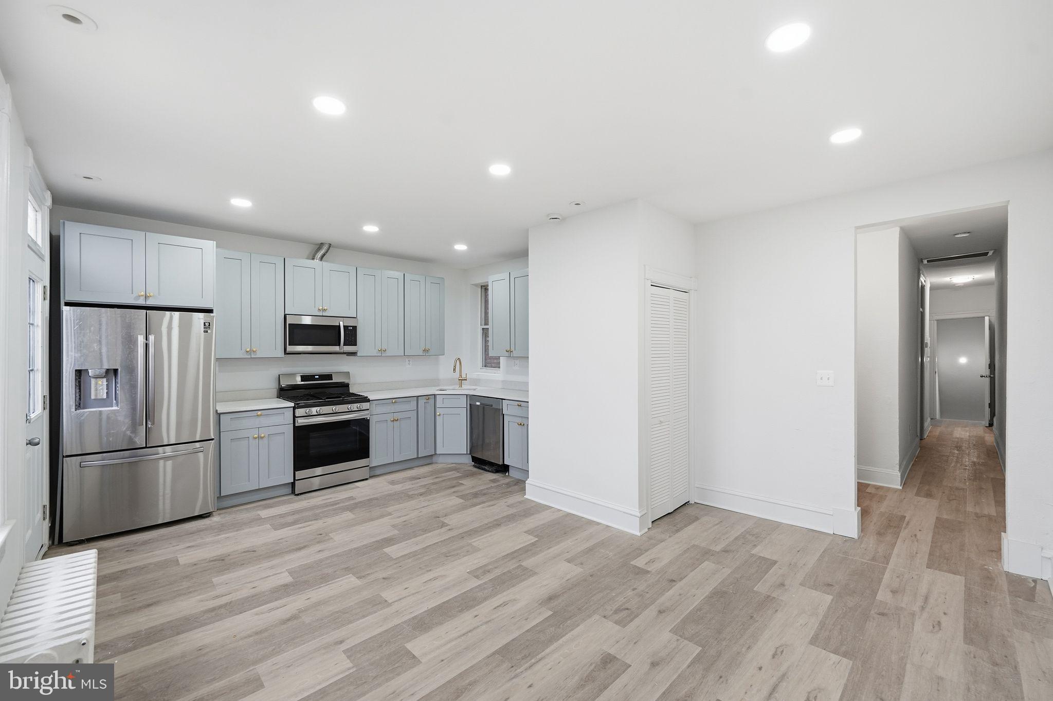 2032 North Capitol Street Northwest, Unit 1 Washington, DC 20002 - Photo 4 of 14 a kitchen with granite countertop a refrigerator and a stove top oven