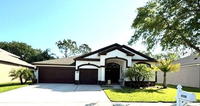 5554 Riva Ridge Drive Wesley Chapel, FL 33544 - Photo 1 of 1 a front view of a house with garden