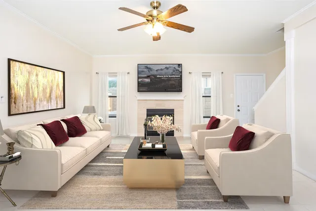 a living room with furniture a fireplace and a flat screen tv