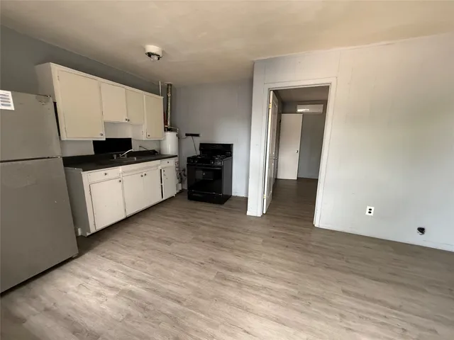 a kitchen with stainless steel appliances a refrigerator sink and cabinets