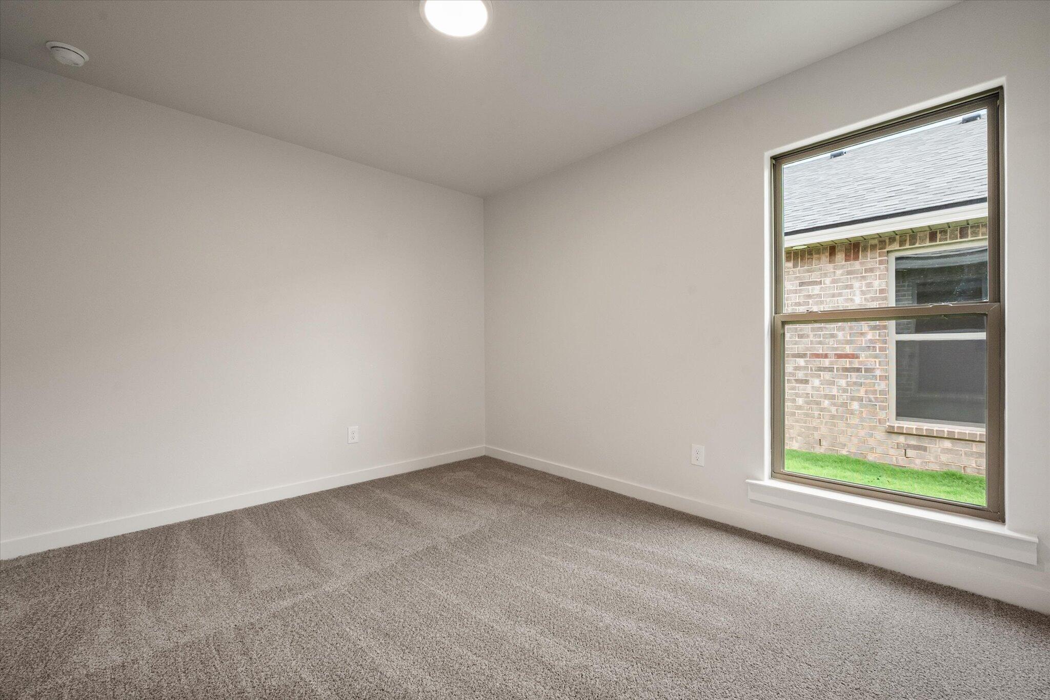 7215 8th Street Lubbock, TX 79416 - Photo 16 of 21 an empty room with a window