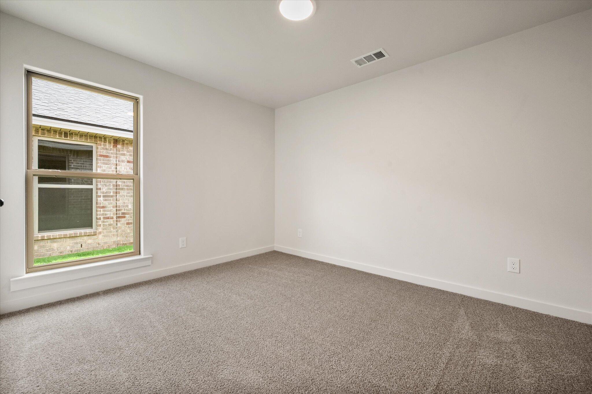 7215 8th Street Lubbock, TX 79416 - Photo 17 of 21 an empty room with a window