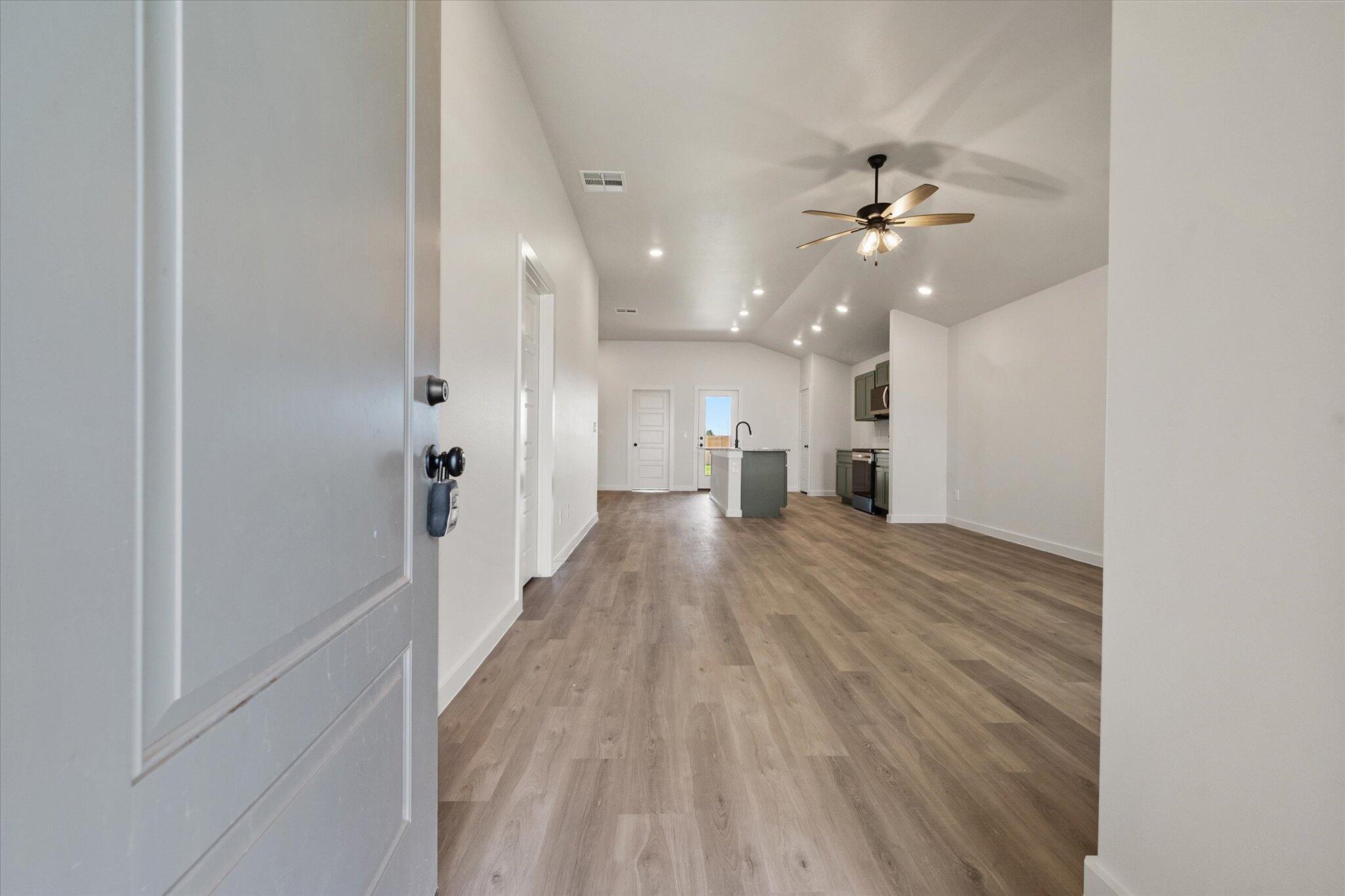 7215 8th Street Lubbock, TX 79416 - Photo 2 of 21 a view of a hallway with wooden floor