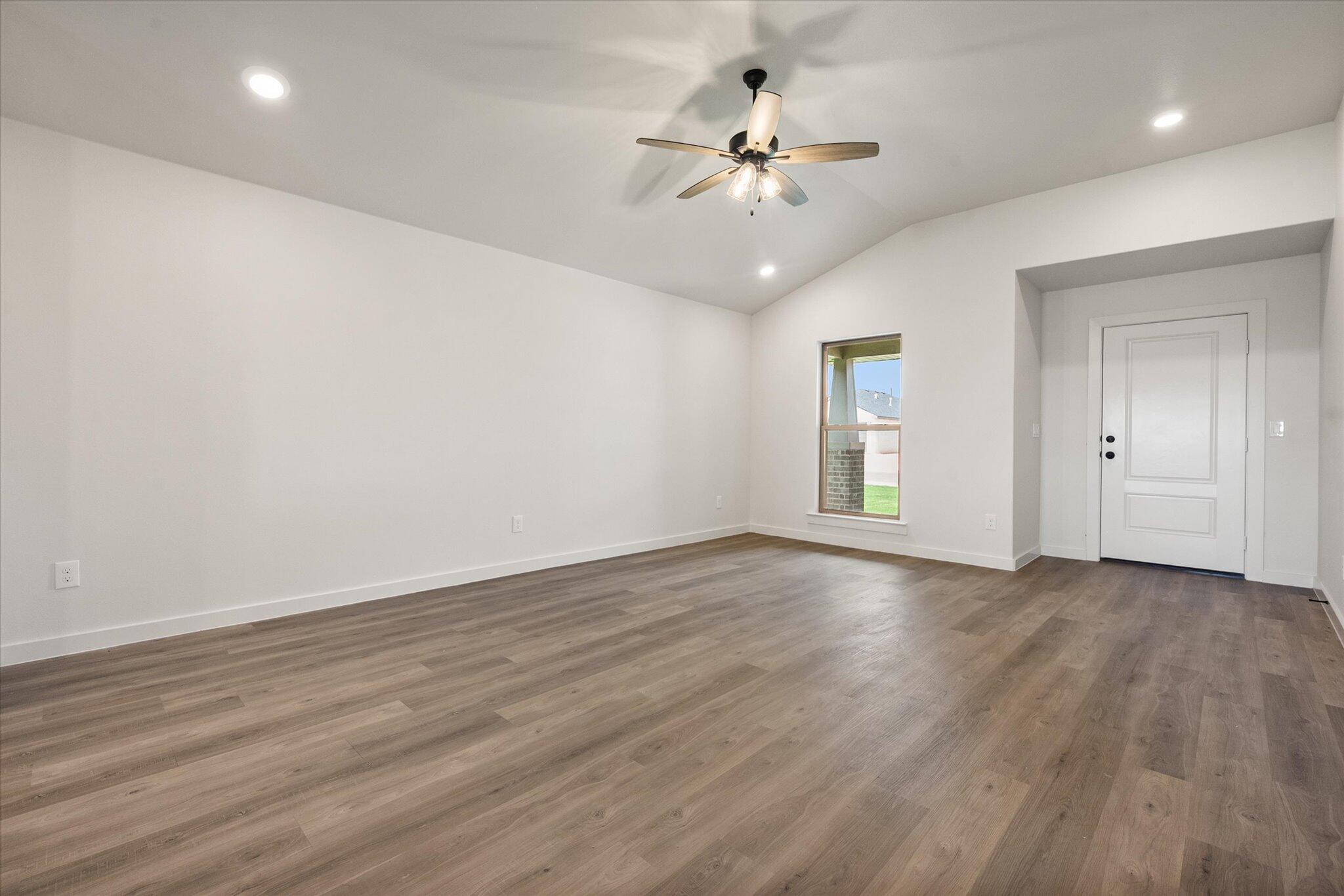 7215 8th Street Lubbock, TX 79416 - Photo 5 of 21 wooden floor in an empty room with a window