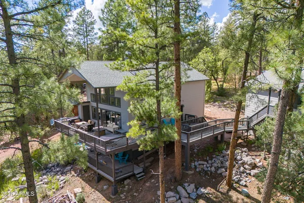 a backyard of a house with chairs and a fire pit
