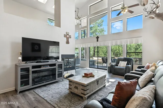 a view of a dining room with furniture a chandelier and wooden floor