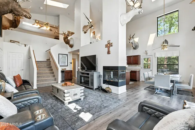 a living room with furniture flat screen tv and a table