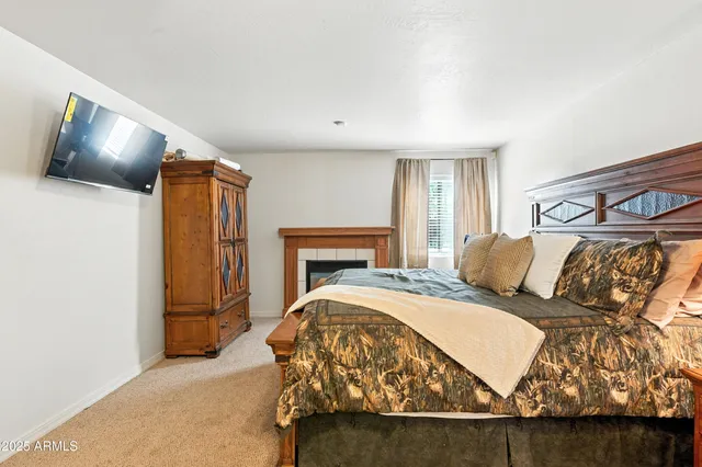 a bedroom with two beds and a chandelier