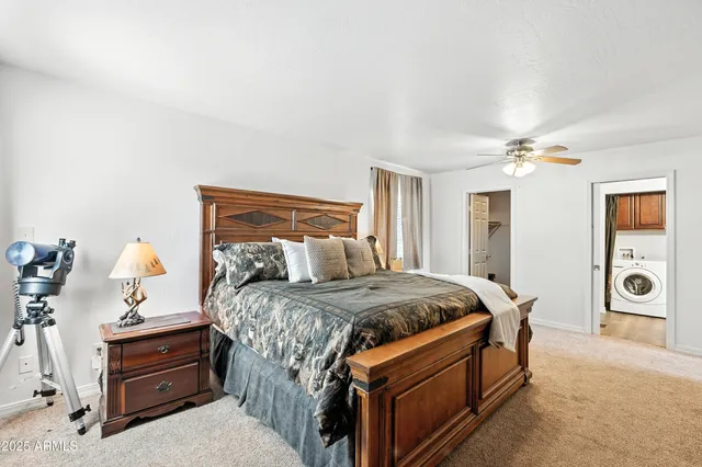 a bedroom with a bed and a chandelier