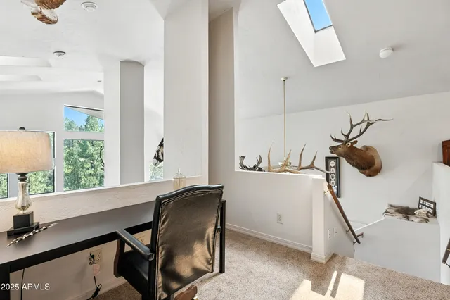 a view of a patio with two couches and deck with wooden floor and fence