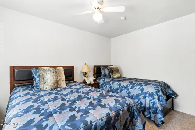 a vase of flowers sitting on a table with chairs