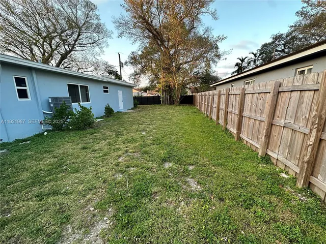 a view front of house with backyard and trees