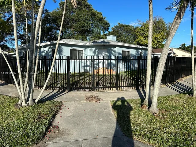 a view of a deck with a floor to ceiling window and wooden fence