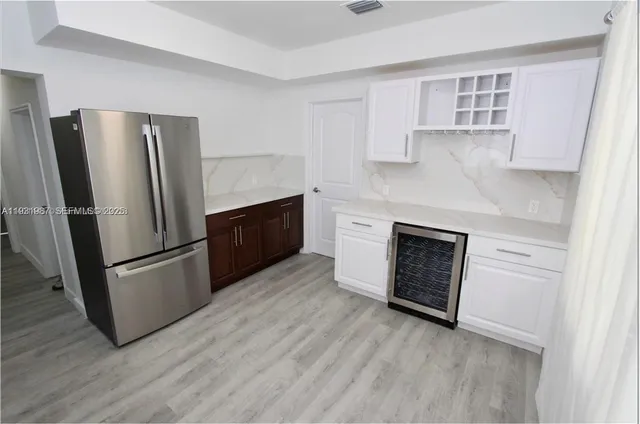 a kitchen with stainless steel appliances a refrigerator sink and microwave