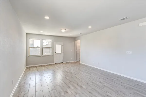 a view of kitchen with kitchen island and stainless steel appliances