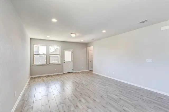 a view of kitchen with kitchen island and stainless steel appliances