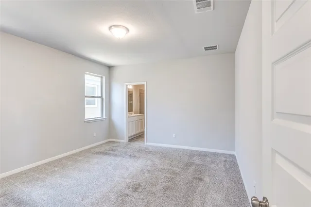a kitchen with a refrigerator a stove top oven a sink and cabinets