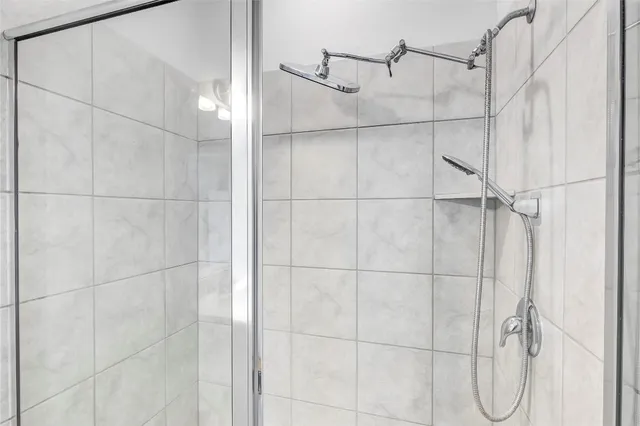 a bathroom with a shower sink vanity and mirror