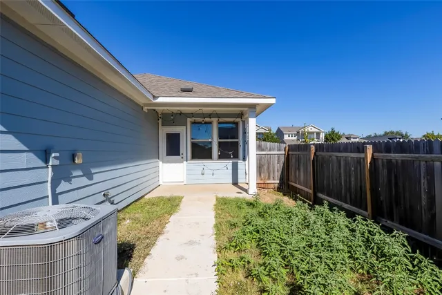 a view of a backyard with potted plants
