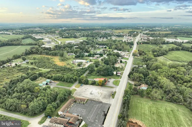 an aerial view of residential houses with outdoor space and river