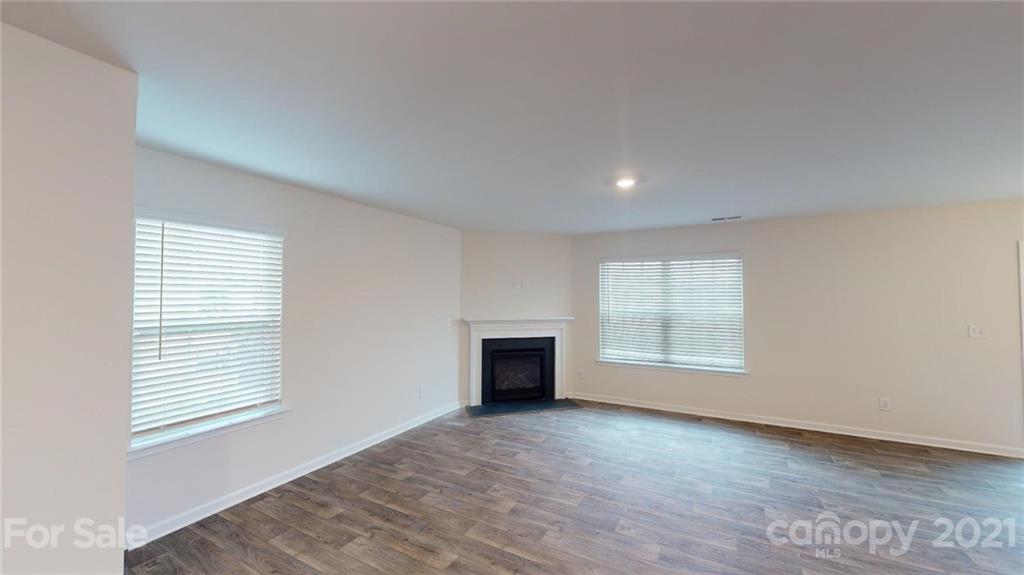 321 Gaines Road Clover, SC 29710 - Photo 4 of 43 an empty room with a fireplace and windows