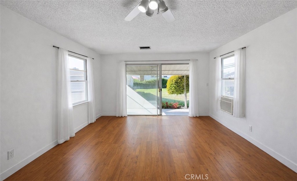 6767 North Ruthlee Avenue San Gabriel, CA 91775 - Photo 30 of 48 Virtually enhanced photo of the family room with the wood panels removed and new floors