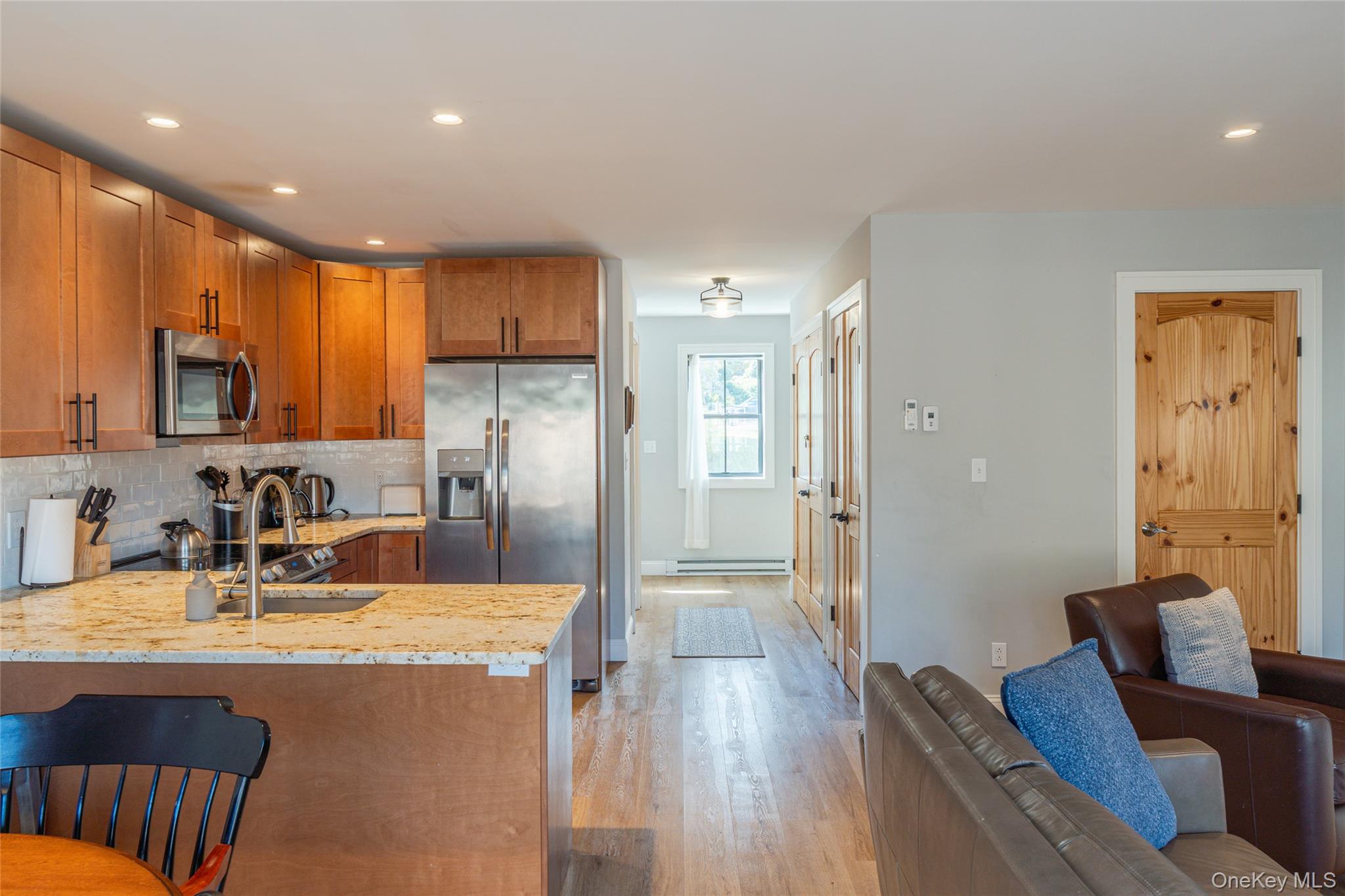 71 County Road 65, Unit 6 Windham, NY 12439 - Photo 13 of 38 a kitchen with stainless steel appliances granite countertop a refrigerator a sink a stove a dining table and chairs