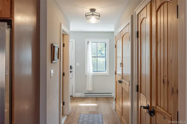 a view of a hallway with wooden floor