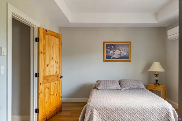 a bedroom with a bed and a painting on the wall