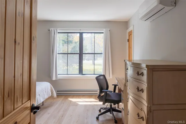 a view of a workspace with furniture and a window