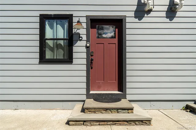 a side view of a house with a porch