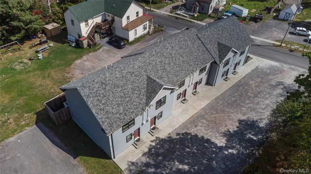 an aerial view of a house with a yard