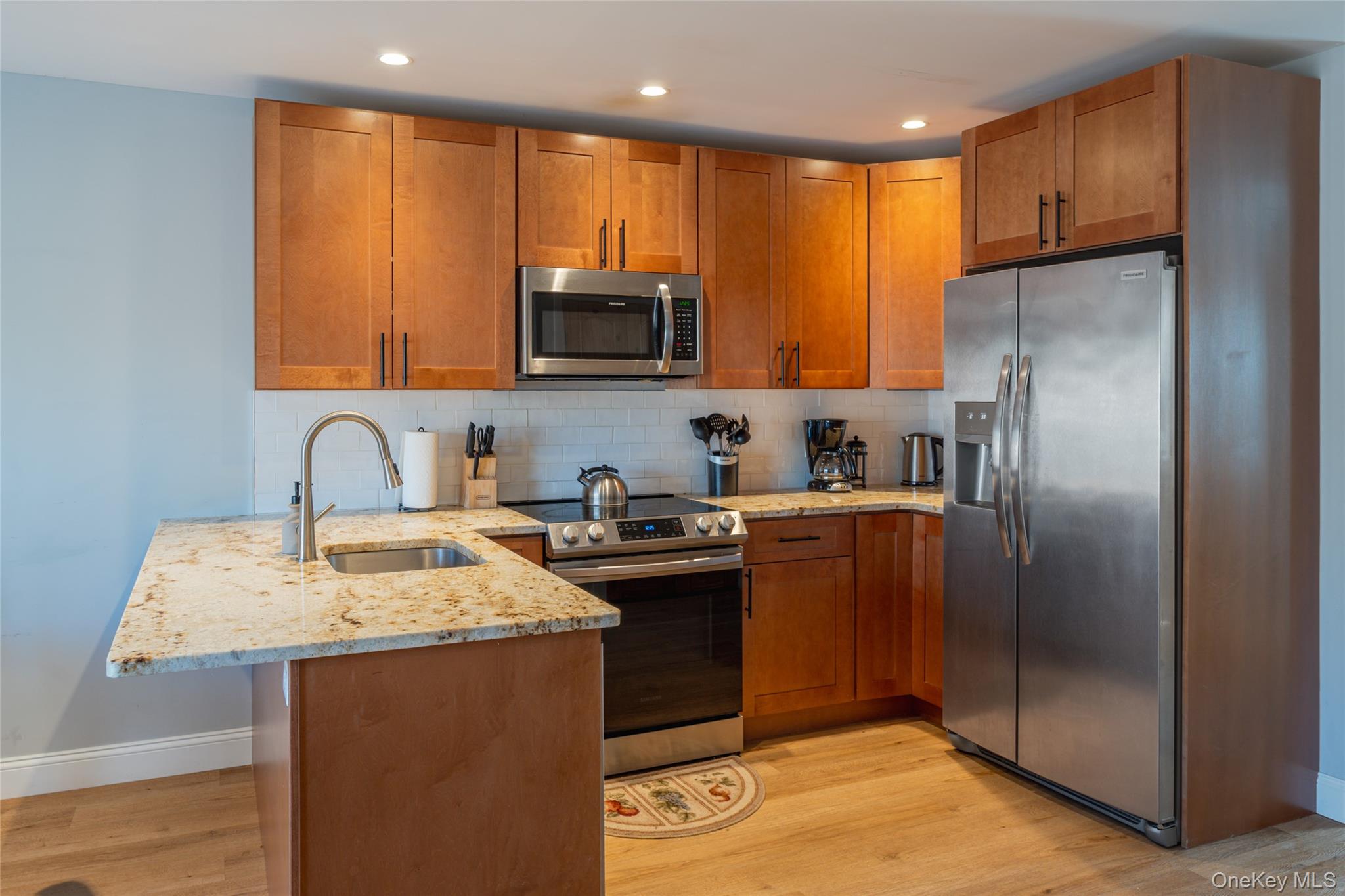 71 County Road 65, Unit 6 Windham, NY 12439 - Photo 4 of 38 a kitchen with stainless steel appliances granite countertop a refrigerator a stove a sink and a microwave