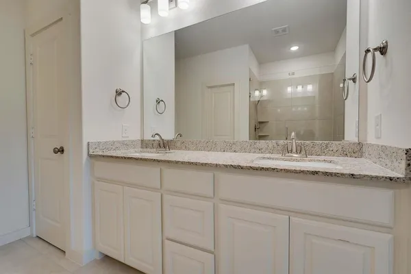 a bathroom with a sink and cabinets