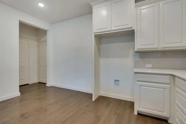a view of an empty room with closet and a window